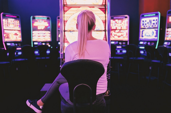 player in front of slot machine